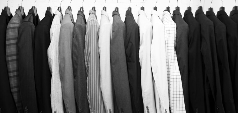 Suits,jacket,hanging,stacked,on,hanger,black,and,white